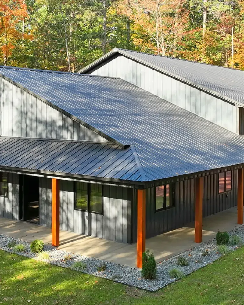 Dark steel building with a covered porch