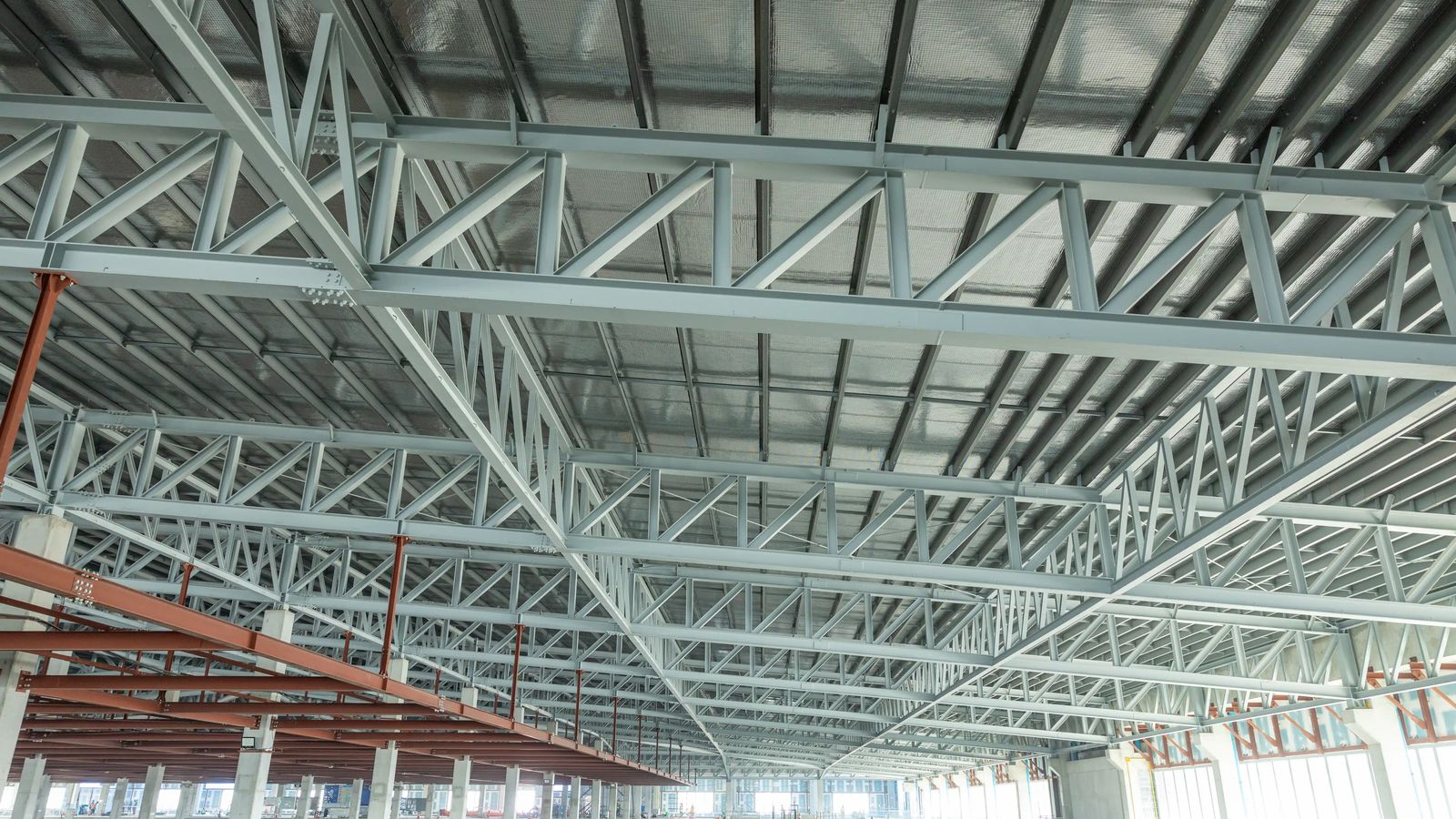 Steel roof trusses spanning a large open building interior