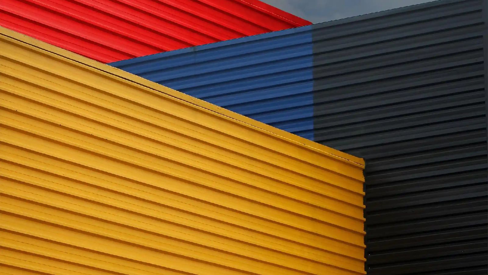 Corrugated metal wall panels in yellow, red, blue, and black