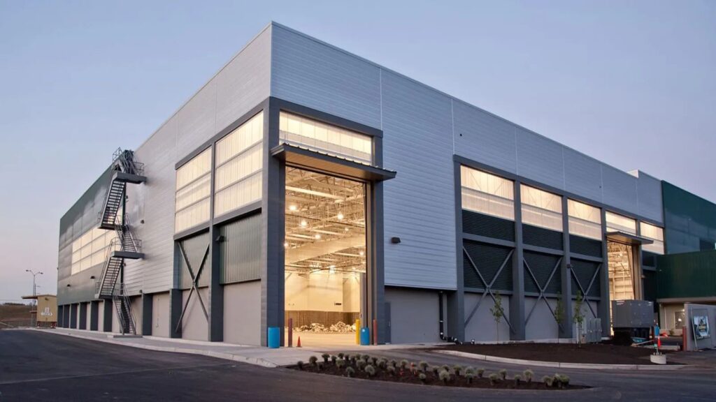 Large commercial steel building with an open overhead door