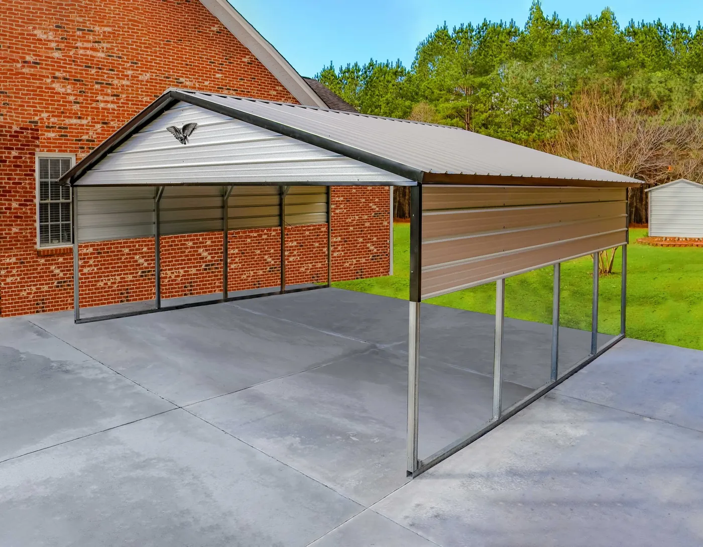 Open steel carport with a gable roof on a concrete pad beside a brick house